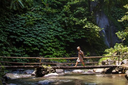 Woman near Nung Nung waterfal on Bali, Indonesiaの写真素材