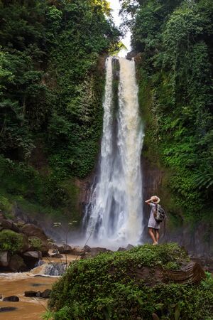 Woman near waterfal Git Git on Bali, IndonesiaÂ の写真素材