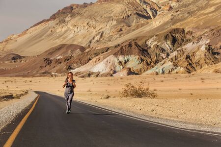 hitchhiker woman walking on a road in USAの写真素材