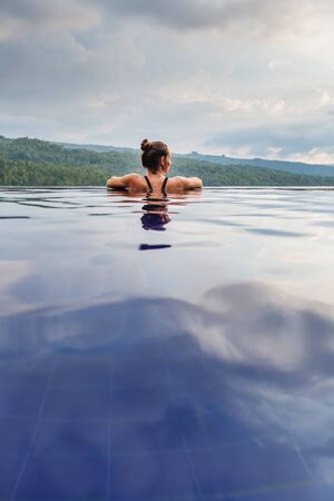 Beautiful woman by the poolの写真素材