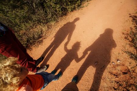 A man with his son are hiking in mountainsの写真素材