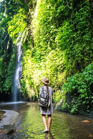 Woman near waterfal on Bali, IndonesiaÂ の写真素材
