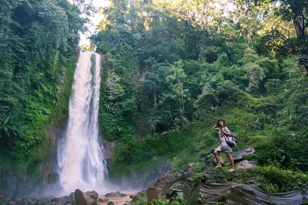 Woman near waterfal Git Git on Bali, IndonesiaÂ の写真素材