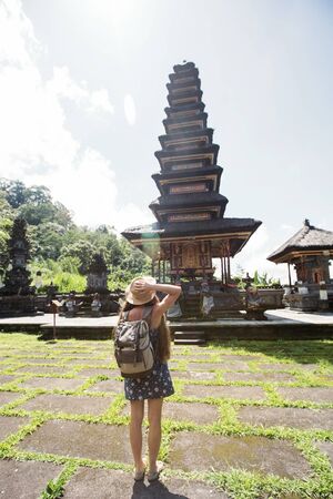 Woman tourist in a temple on the island of Baliの写真素材