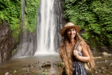 Woman near Munduk waterfal on Bali, Indonesiaの写真素材