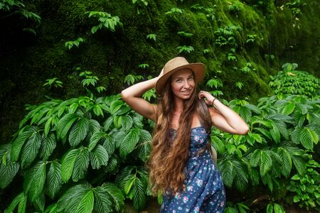 Woman near waterfal on Bali, IndonesiaÂ の写真素材