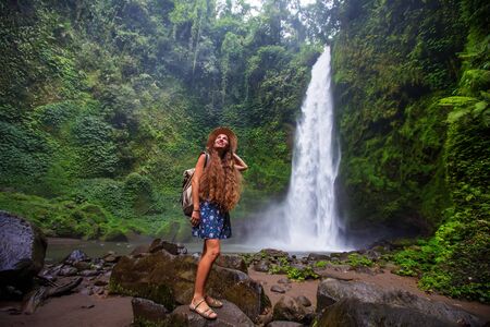 Woman near Nung Nung waterfal on Bali, Indonesiaの写真素材