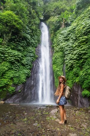 Woman near Munduk waterfal on Bali, Indonesiaの写真素材