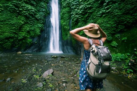 Woman near Munduk waterfal on Bali, Indonesiaの写真素材