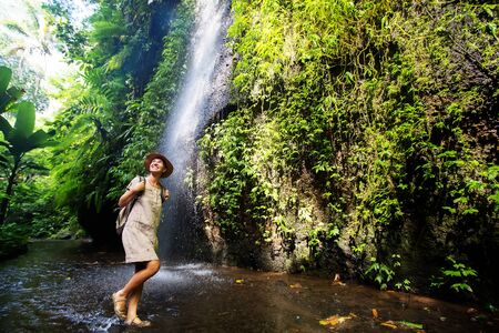 Woman near waterfal on Bali, IndonesiaÂ の写真素材