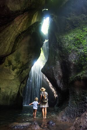 Mother with son near waterfal on Bali, IndonesiaÂ の写真素材