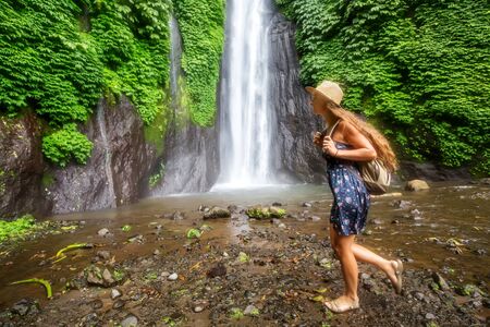 Woman near Munduk waterfal on Bali, Indonesiaの写真素材