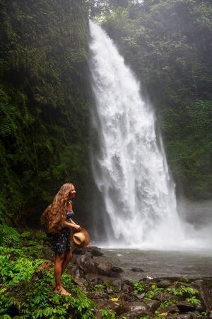 Woman near Nung Nung waterfal on Bali, Indonesiaの写真素材