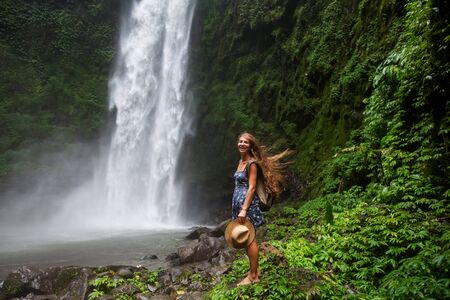 Woman near Nung Nung waterfal on Bali, Indonesiaの写真素材