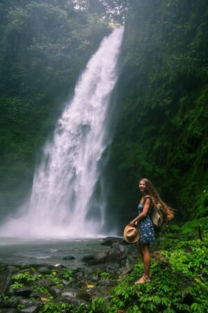 Woman near Nung Nung waterfal on Bali, Indonesiaの写真素材