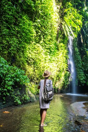 Woman near waterfal on Bali, IndonesiaÂ の写真素材