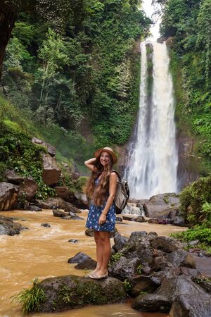 Woman near waterfal Git Git on Bali, IndonesiaÂ の写真素材
