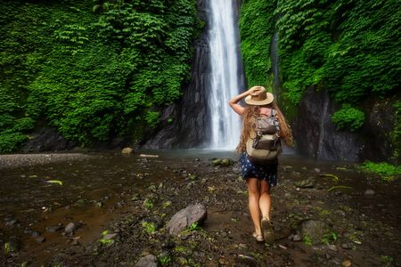 Woman near Munduk waterfal on Bali, Indonesiaの写真素材