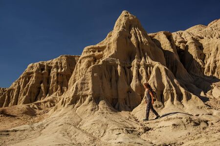 A hiker in the Artist`s Palette landmark place in Death Valley National Park, Geology, sand.の写真素材