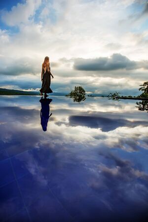 Beautiful woman by the poolの写真素材