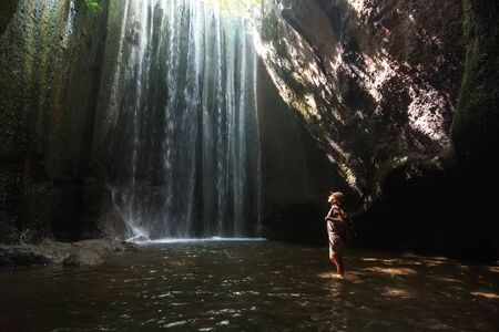 Woman near waterfal on Bali, IndonesiaÂ の写真素材
