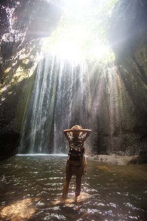 Woman near waterfal on Bali, IndonesiaÂ の写真素材