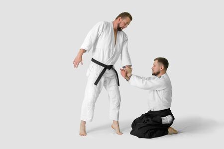 Two caucasian men are practicing aikido on the tatami (isolation path included)の写真素材