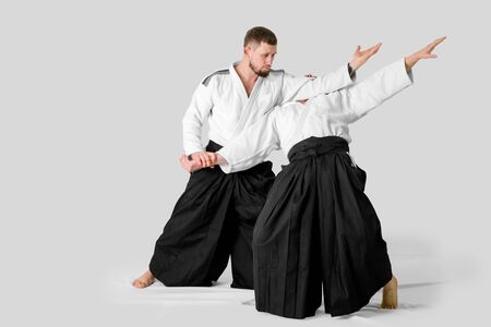 Two caucasian men are practicing aikido on the tatami (isolation path included)の写真素材