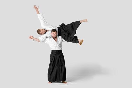 Two caucasian men are practicing aikido on the tatami (isolation path included)の写真素材