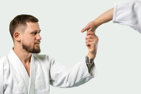 Two caucasian men are practicing aikido on the tatami (isolation path included)の写真素材
