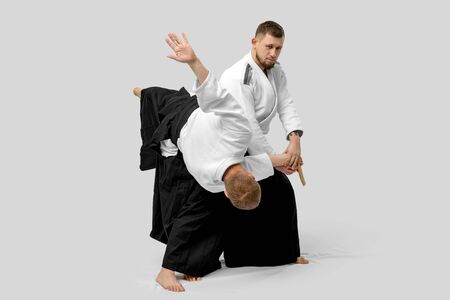 Two caucasian men are practicing aikido with waakizashi (isolation path included)の写真素材