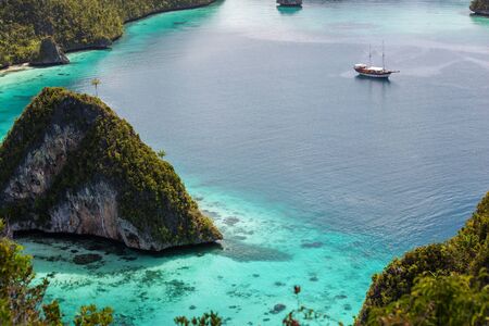View from the top of the cliff at remote archipelago Pulau Wayag, Raja Ampat, Indonesiaの写真素材