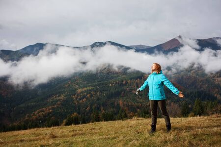 Hiker woman in moumtains in autumnの写真素材