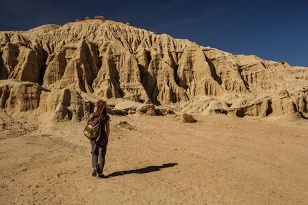 A hiker in the Artist`s Palette landmark place in Death Valley National Park, Geology, sand.の写真素材