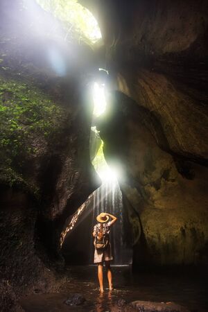 Woman near waterfal on Bali, IndonesiaÂ の写真素材