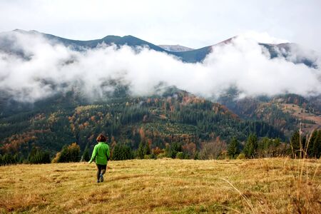 Hiker woman in moumtains in autumnの写真素材