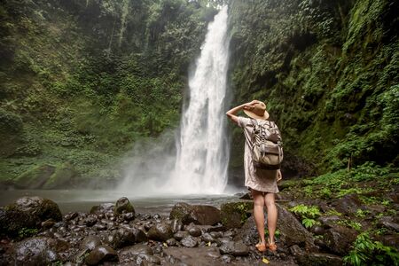 Woman near Nung Nung waterfal on Bali, Indonesiaの写真素材