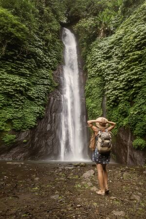 Woman near Munduk waterfal on Bali, Indonesiaの写真素材