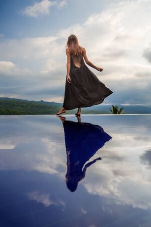 Beautiful woman by the poolの写真素材