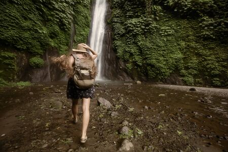 Woman near Munduk waterfal on Bali, Indonesiaの写真素材