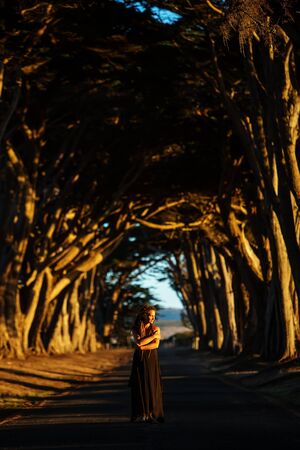 Happy girl in a tunnel with treesの写真素材