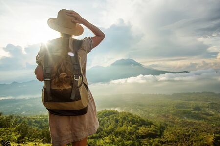 Woman enjoying sunrise from a top of mountain Batur, Bali, Indonesia.
の写真素材