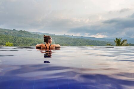 Beautiful woman by the poolの写真素材