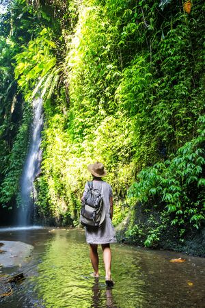 Woman near waterfal on Bali, IndonesiaÂ の写真素材