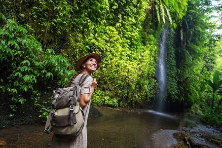 Woman near waterfal on Bali, IndonesiaÂ の写真素材