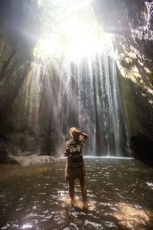 Woman near waterfal on Bali, IndonesiaÂ の写真素材