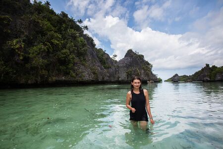 Tourists at the Yapap rock formation, Misool region, Raja Ampat South, Papua, Indonesiaの写真素材