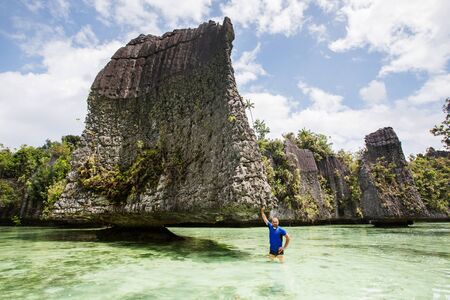 Tourists at the Yapap rock formation, Misool region, Raja Ampat South, Papua, Indonesiaの写真素材