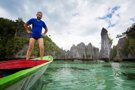 Tourists at the Yapap rock formation, Misool region, Raja Ampat South, Papua, Indonesiaの写真素材