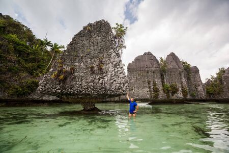 Tourists at the Yapap rock formation, Misool region, Raja Ampat South, Papua, Indonesiaの写真素材